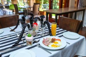 a table with a plate of food on a table at Thaba Legae Guest Lodge in Rustenburg