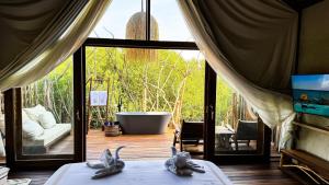 Zimmer mit Badewanne und Bett in einem Zimmer in der Unterkunft CASA MIKOKO in Umm al-Qaiwain