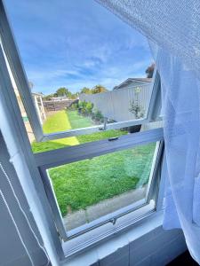 a window with a view of a yard at House of Somer in Matamata