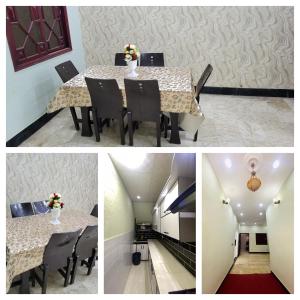 a dining room table with black chairs and flowers on it at Jinnah inn Guest House in Karachi