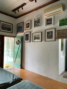 a bedroom with a wall with pictures on it at Cọ cùn homestay/ Handmade/ Artwork (2 beds) in Buon Ma Thuot