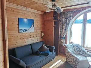 a living room with a couch and a tv at Zirbennest in Serfaus