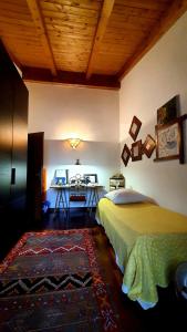 a bedroom with a bed and a table in it at Elena Paternoster in San Lazzaro di Savena