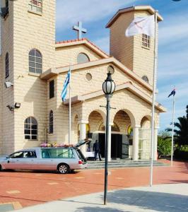 a car parked in front of a church with a cross at House in Thomastown in Melbourne