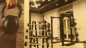 a room with a bunch of exercise equipment at Stargazers cozy apartment with direct Metro access in Dubai
