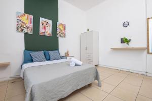 a bedroom with a bed and a green wall at Godson down town in Haifa