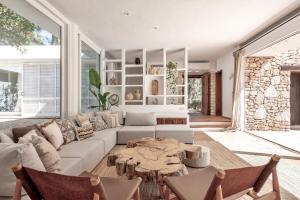 a living room with a couch and a table at Villa Sa Tanca IBIZA located PUIG D'EN VAll, 6B , Pool , Tennis in Montecristo