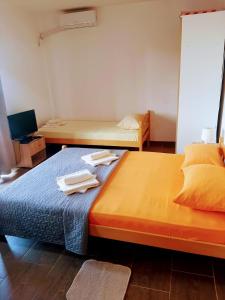 two beds in a room with towels on the bed at Promenada in Veliko Gradište