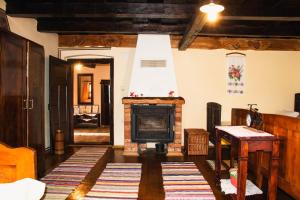 a living room with a fireplace and a tv at Country House Ivančan in Molve