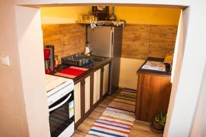 a small kitchen with a stove and a refrigerator at Country House Ivančan in Molve