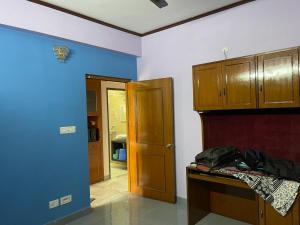 a room with a blue and white wall and a door at South-East-West Facing 3 BHK Lakeview Flat Howrah West Bengal in Howrah