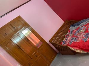 a bedroom with a bed and a wooden dresser at South-East-West Facing 3 BHK Lakeview Flat Howrah West Bengal in Howrah