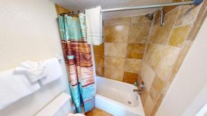 a bathroom with a shower and a toilet at Island Inn Beach Resort in St Pete Beach