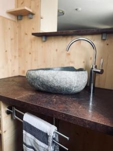 a stone sink on a counter in a bathroom at Landhaus Riedl in Bad Füssing