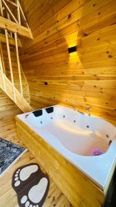 uma banheira de hidromassagem num quarto de madeira em Greenlife Dağevleri em Rize
