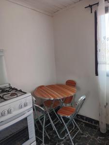 a small kitchen with a table and a stove at MIKEA in Antananarivo