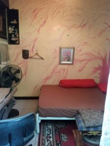 a bedroom with a bed and a pink wall at GN GOOD NICE in Bangkok
