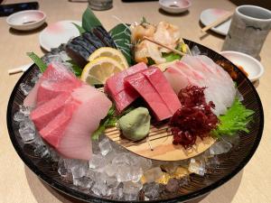 a plate of food with sushi on a table at Kashiwanoha Hotspring Garden Villa&Suite Room in Kashiwa