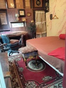 a room with a bed and a table and a rug at GN GOOD NICE in Bangkok