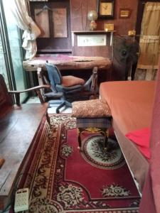 a room with a table and a chair and a rug at GN GOOD NICE in Bangkok