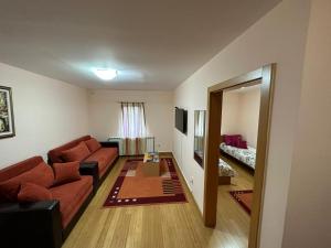 a living room with a couch and a table at Apartmani Ušće in Trstenik