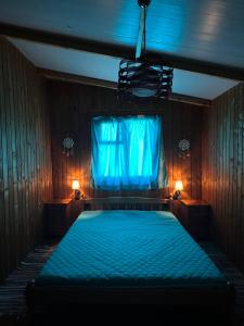 a bedroom with a blue bed with a window at Blue Oasis Lozenets in Kiten