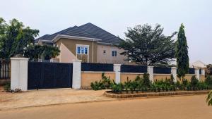 a house with a fence in front of it at Cedarwood Apartments in Abuja