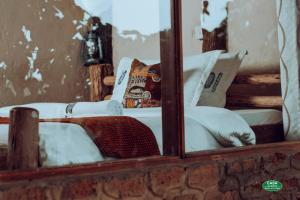 a mirror reflection of a chair with a skateboard on it at Sipi Falls Lodge in Sipi