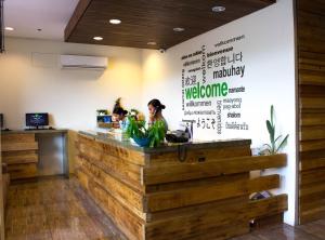 a restaurant with a wooden counter with two women sitting at it at Cebu R Hotel Mabolo in Cebu City