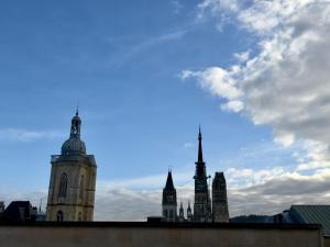 a group of buildings against a cloudy sky at Rouen Hypercentre - Le relais des Amis in Rouen