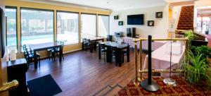 una sala de estar con mesas y sillas y un comedor. en The Morgan Hotel San Simeon en San Simeon