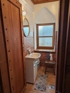 a bathroom with a sink and a toilet and a window at National Monument Konak in Stolac