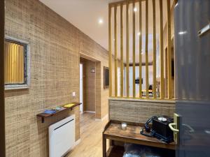 a room with a table and a mirror on a wall at Rouen Hypercentre - Le relais des Amis in Rouen +27 photos