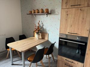 a kitchen with a wooden table and chairs at Goldene Krone in Belgershain