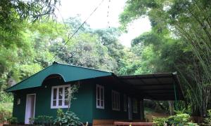 a small green house in the woods at Verdant Hillock in Wayanad