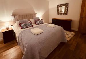 a bedroom with a large bed with pillows on it at Highfield in Rous Lench