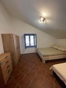 a bedroom with a bed and a window in it at Apartment Atina in Kotor