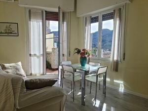 a living room with a table and chairs and a couch at Partenope in Levanto