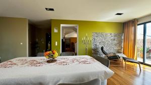 a dining room with a table with a vase on it at Casa dos Arrifes in Funchal