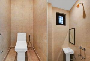 a bathroom with a toilet and a sink at MOHAN VILLA in New Delhi