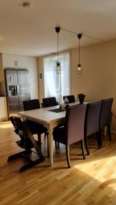 a dining room with a wooden table and chairs at Trevlig lägenhet nära Strömstad centrum in Strömstad