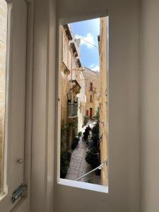 a view from a window of a street at Domingo x Casa Norte in Birgu