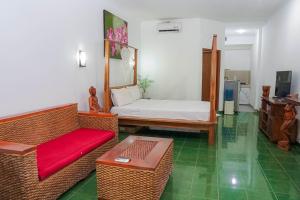 a living room with a couch and a bed at Panorama cottages 1 #31 in Legian