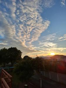 a cloudy sky with the sunset in the background at Airport home Radinovic in Podgorica