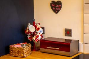 a table with a red drawer and a box at 5 wheelhouse apartments in Lochinver