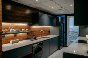 a kitchen with a sink and a dishwasher at Luxury 3 Bedroom Sub Penthouse With Rooftop Pool in Dubai