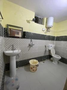 a bathroom with a sink and a toilet at Only Cafe in Rudraprayāg