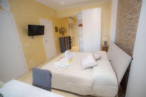a bedroom with a large bed with a stuffed animal on it at Appartamento La Coccinella in Lido di Ostia