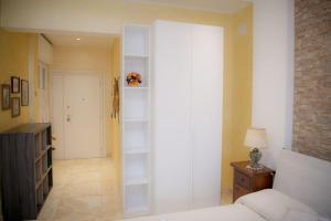 a bedroom with a bed and a book shelf at Appartamento La Coccinella in Lido di Ostia