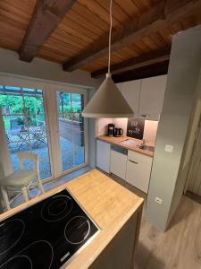 a kitchen with a stove top oven in a room at Cottage & Garden & Sauna am See in Wettringen